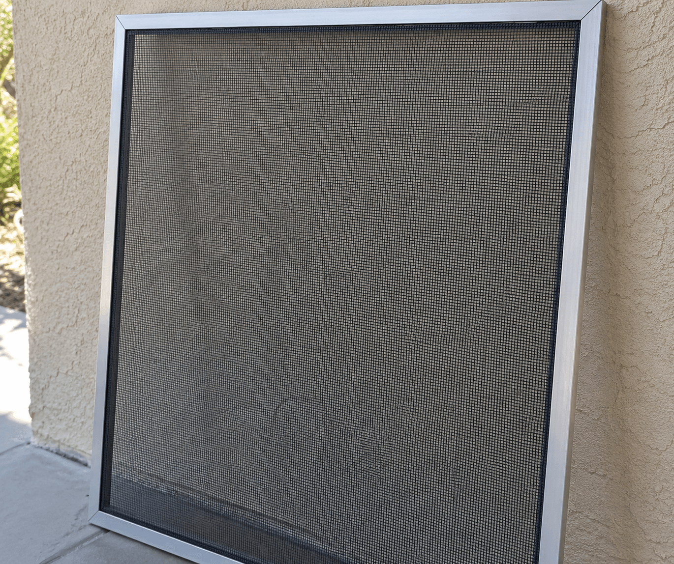 The same window screen after cleaning, the mesh clear