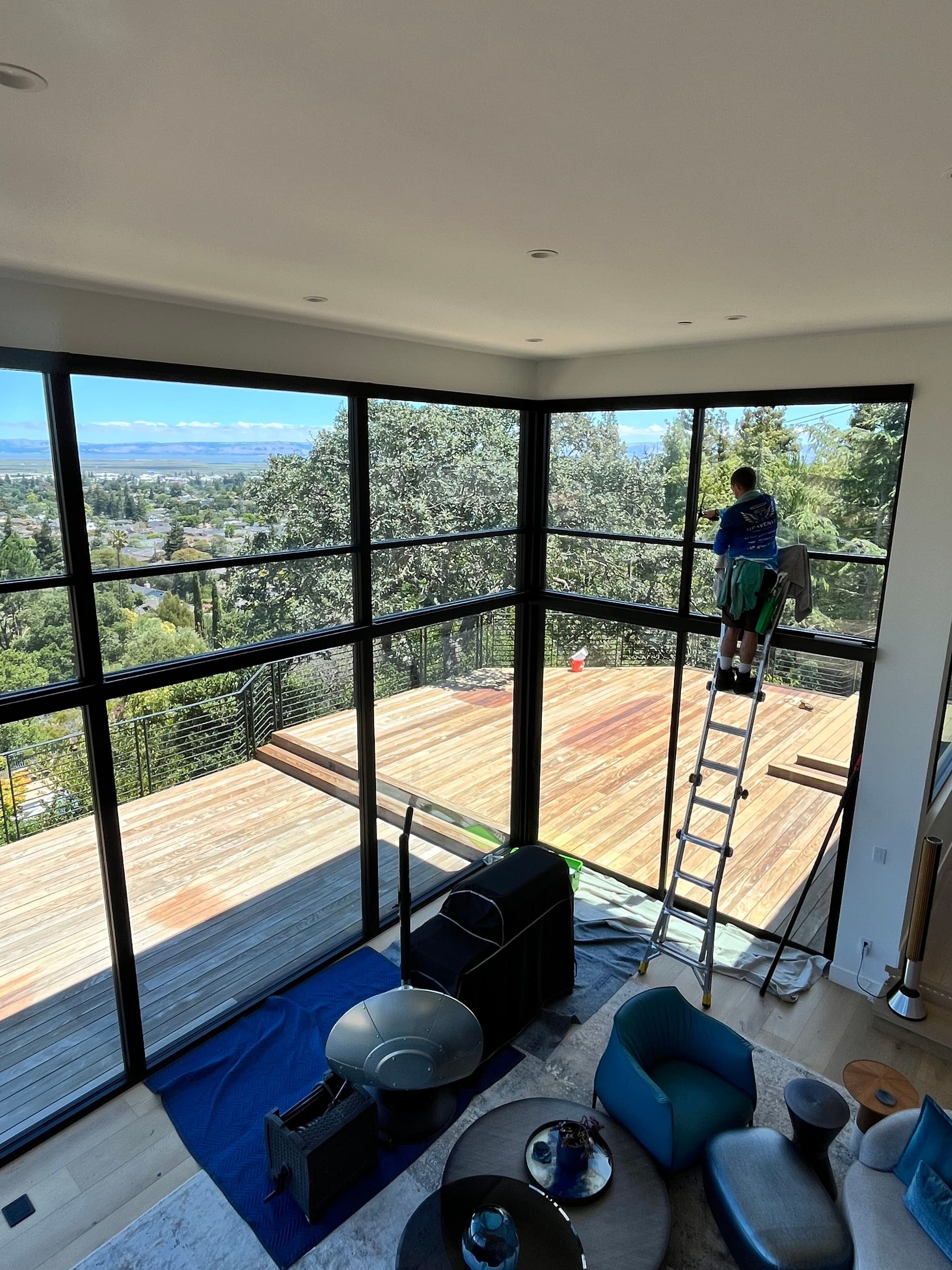 A Heavenly technician carefully cleaning picture windows overlooking the Peninsula
